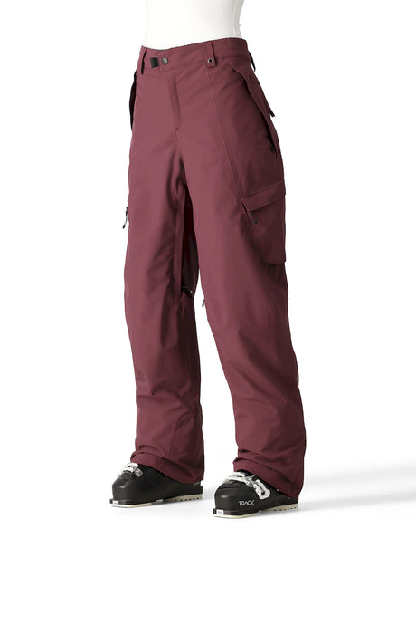 686 Geode Thermagraph women's pant in burgundy, front view on a model showing the cargo pockets and a relaxed fit. Come in to Willi's Ski and Board.