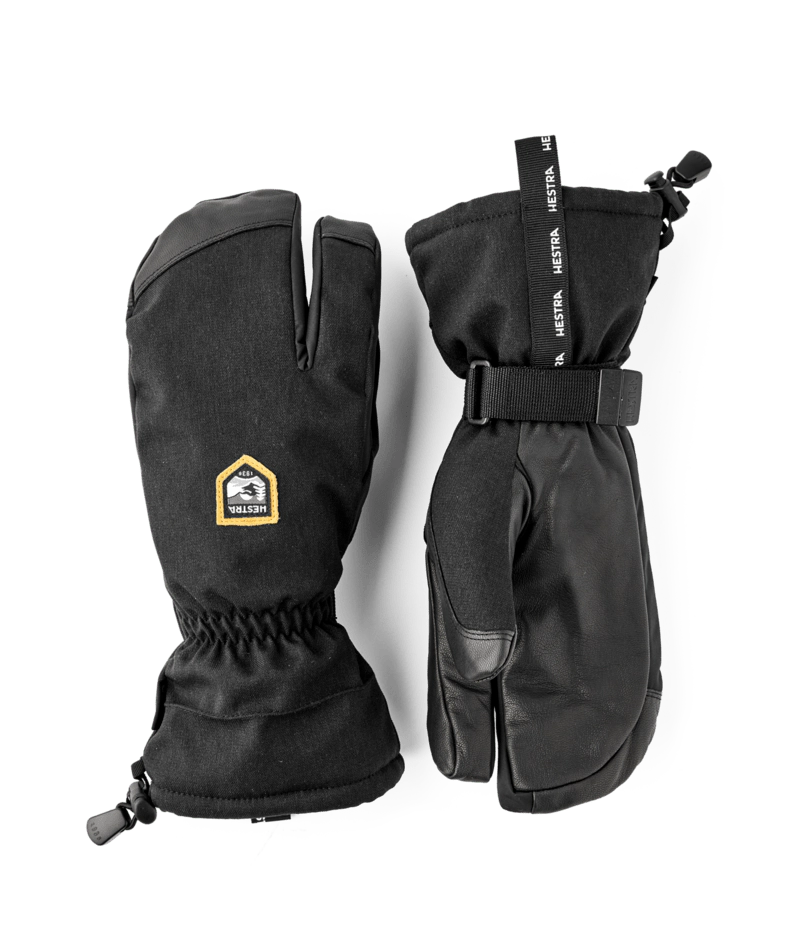 Hestra C-Zone Mountain 3-finger gloves in black with a gold Hestra label, a pair of long cuff gloves with a wrist strap.