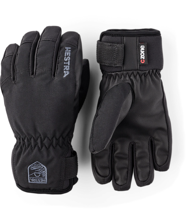 Hestra Ferox junior gloves in black with a C-Zone label and a wrist strap, a pair showing the back and the palm. Come in to Willi's Ski and Board.
