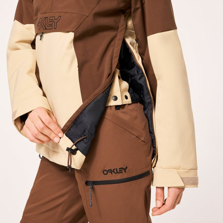 Oakley Tnp Tbt Womens Anorak Jacket ski jacket -- Hummus colorway back view showing articulated powder skirt and fit