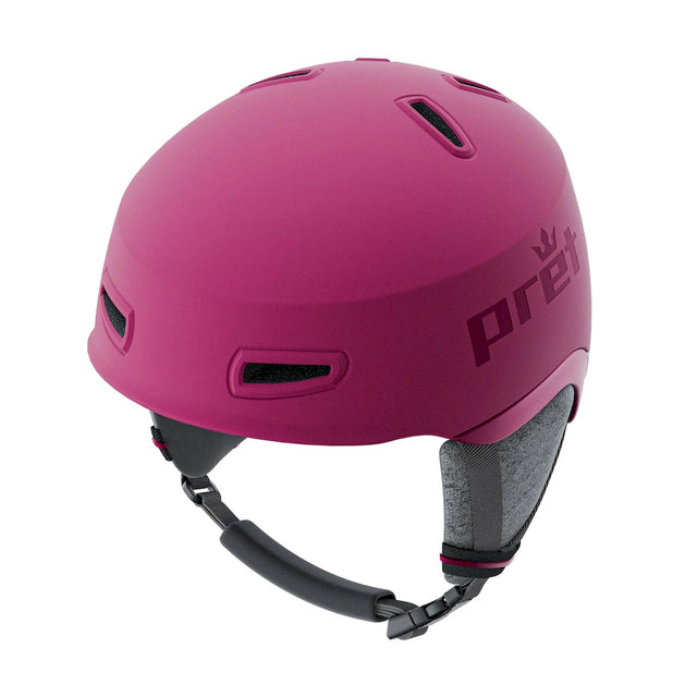 Pret Sol MIPS helmet in berry pink with the Pret name on the side, angled front view showing the vents and the chin strap.