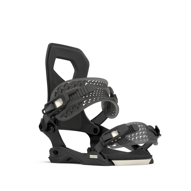 Rome Hydra AW snowboard binding in black with a cream base edge, angled side view of the cut-out highback and the straps.