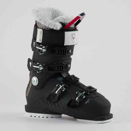 Rossignol Pure 70 women's ski boot in black with a white cuff strap and a fur-lined top, side view showing the buckles. Available at Willi's Ski Shop.
