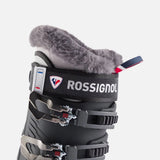 Rossignol Pure Pro 80 women's ski boot in metal ice black, close-up of the fur-lined cuff, the power strap and the Rossignol logo.