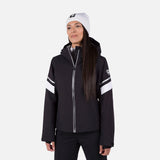 Rossignol Strawpile women's jacket in black with white sleeve stripes, front view on a model wearing a white beanie. Come in to Willi's Ski and Board.
