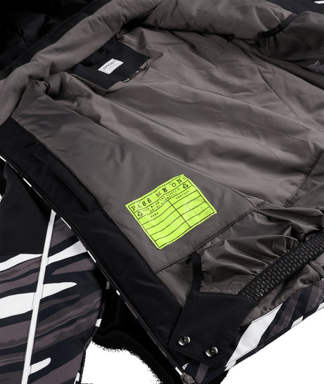 Spyder Conquer Junior Jacket ski jacket -- Tiger Polar 8 colorway lifestyle view showing full jacket silhouette
