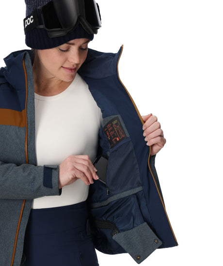 Spyder Lightning Electric Womens Jacket 2026 ski jacket -- True Navy colorway front view on model with hood and cuffs