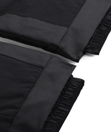 Spyder Propulsion Junior Pant ski pant -- Black colorway side view showing side zip ventilation