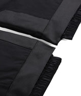 Spyder Propulsion Junior Pant 2026 ski pant -- Black colorway side view showing side zip ventilation