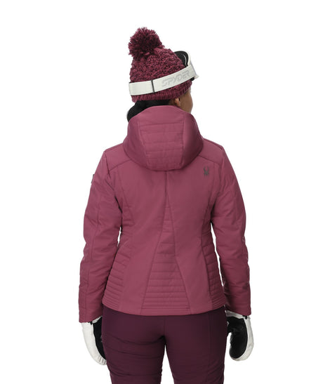 Spyder Schatzi Womens Jacket 2026 ski jacket -- Acai colorway front view on model with hood and cuffs